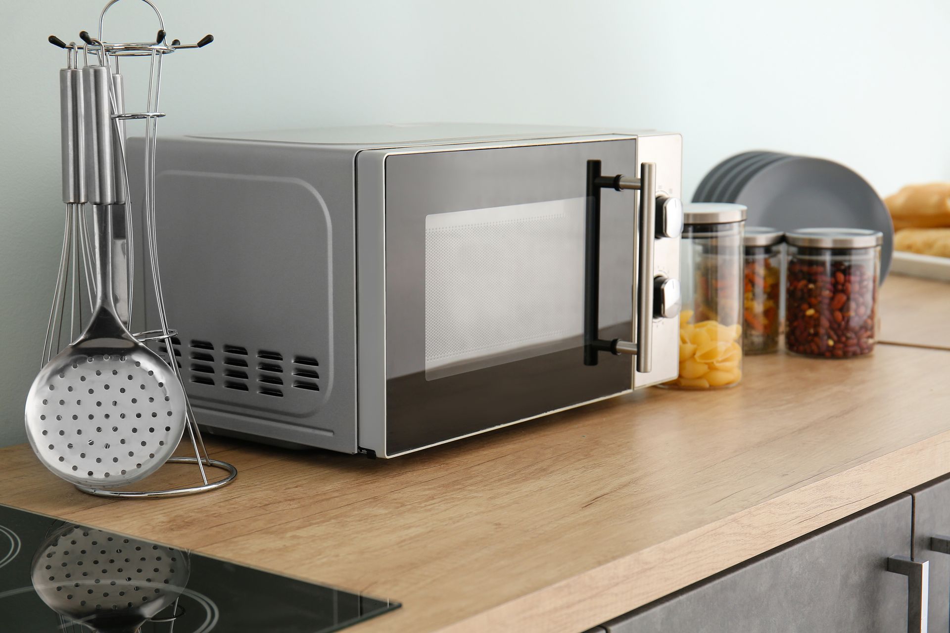 Dishwasher with white dishes and silverware loaded inside, ready to be washed.