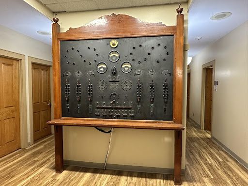 a large blackboard is hanging on a wall in a hallway .