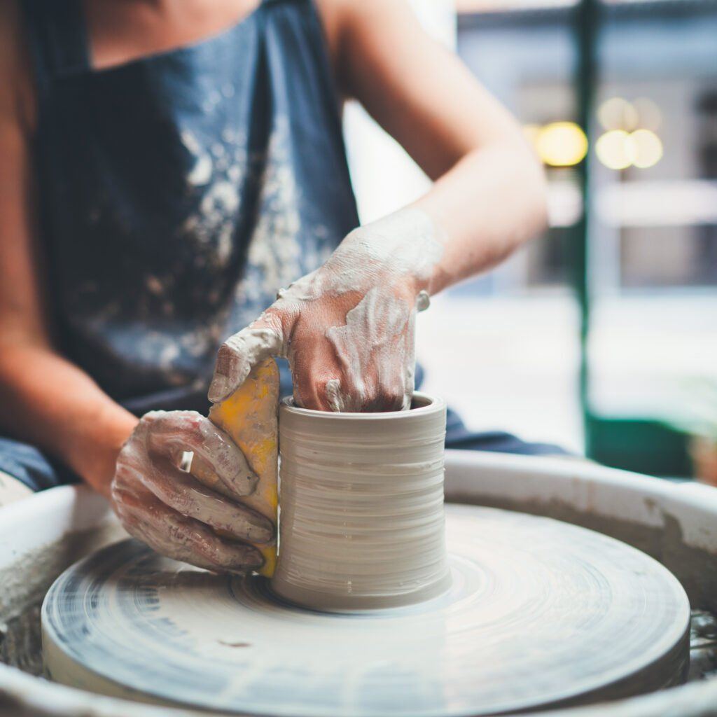 A woman making a cermic pot