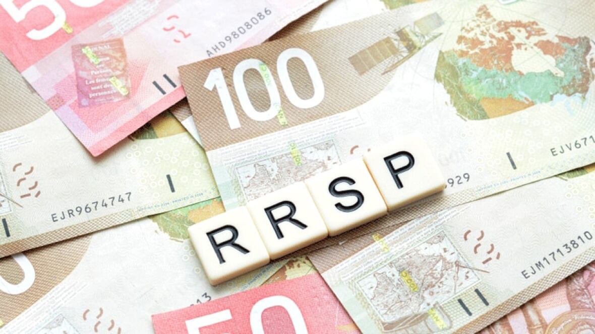 the word RRSP spelled with scrabble blocks on a pile of money