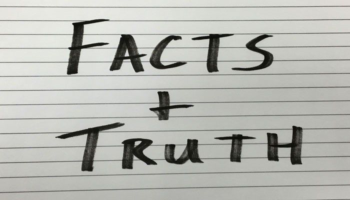 a piece of paper with the words fact and truth written on it.