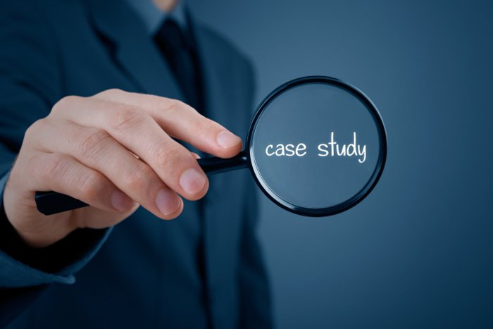 a man in a suit holding a magnifying glass with the word case study.