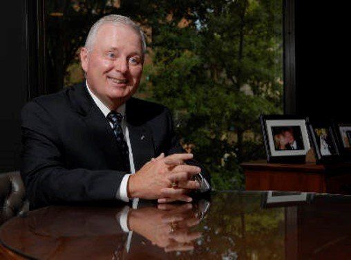 a man in a suit and tie sitting at a table.