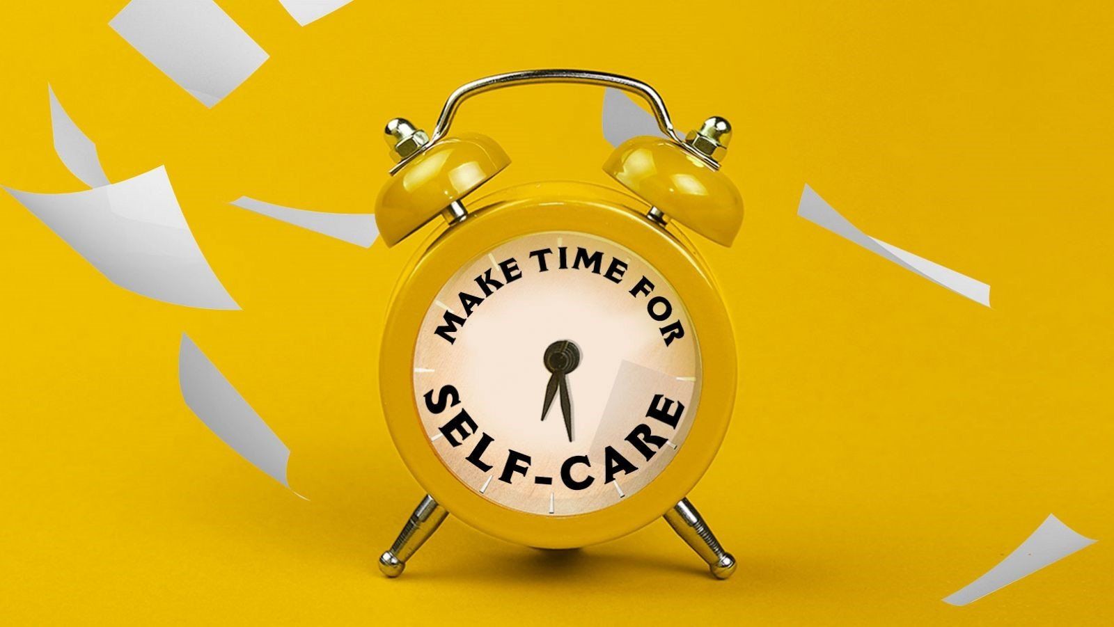 a yellow alarm clock with the words make time for self care on it