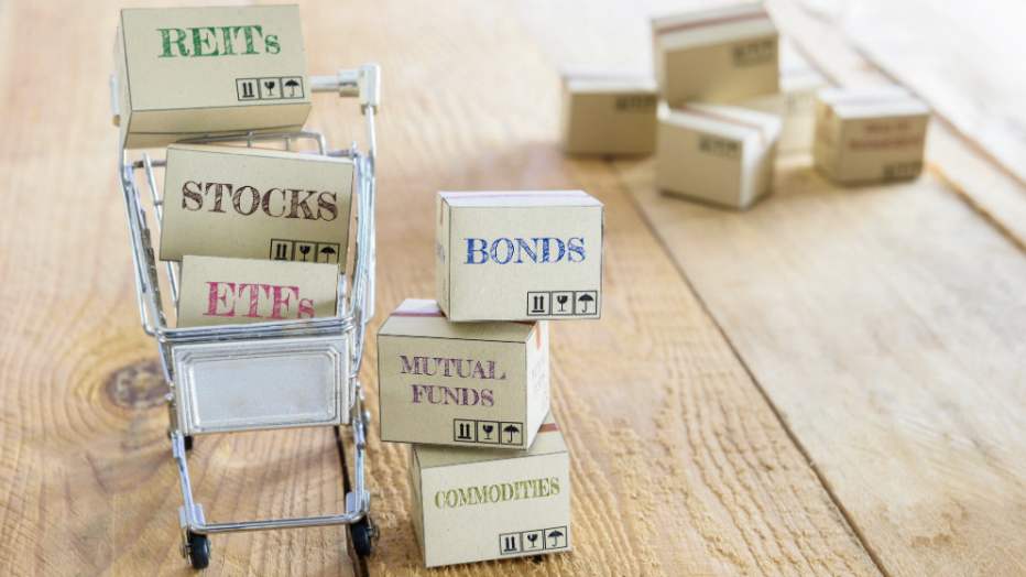 a stack of tiny moving boxes sitting on top of a wooden table with financial terms on them