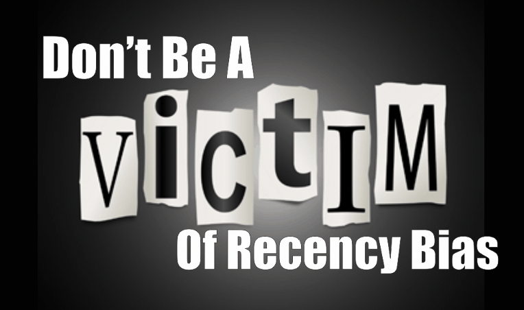 The words Don't be a victim of recency bias with the word victim written in cut out letters.