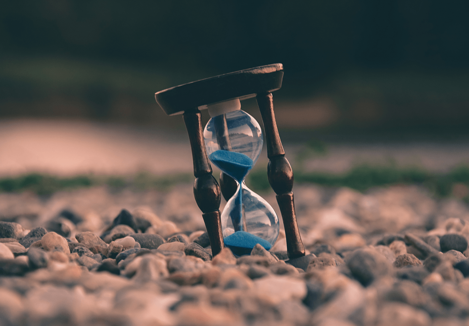 hourglass on a rock beach