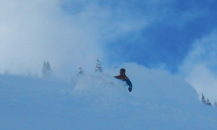 Dean snowboarding down a ski hill