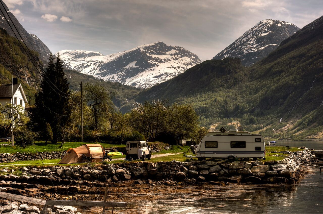 Trailer parked by a Lake in the Mountains