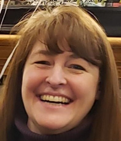 A close up of a woman 's face smiling.