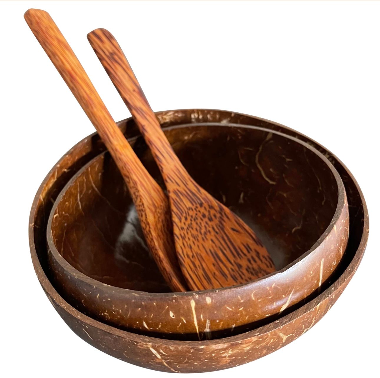 Two coconut bowls nested with two wooden spoons.