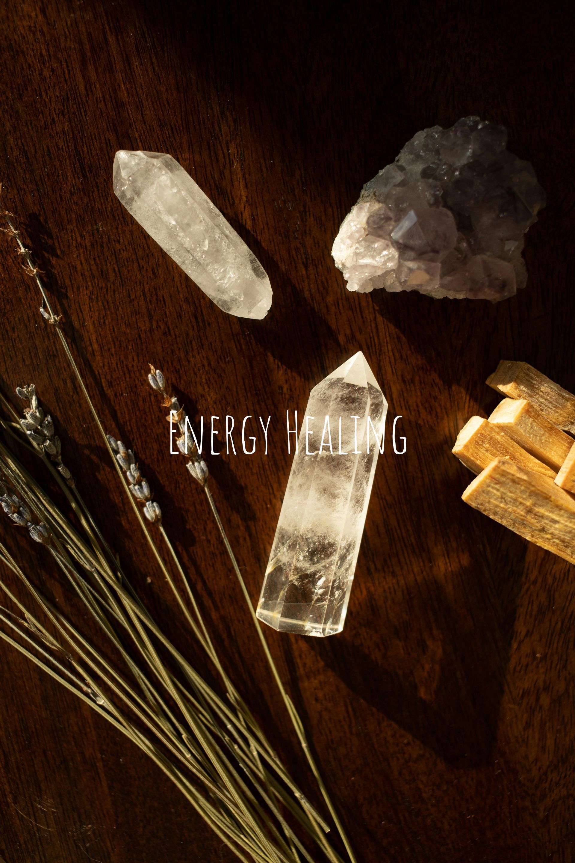 Crystals, palo santo, and lavender on a wooden surface with the words