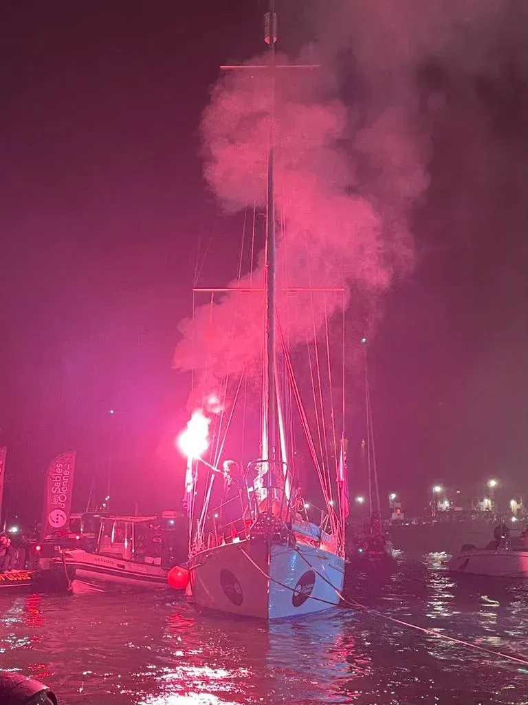 A boat in the water with smoke coming out of it