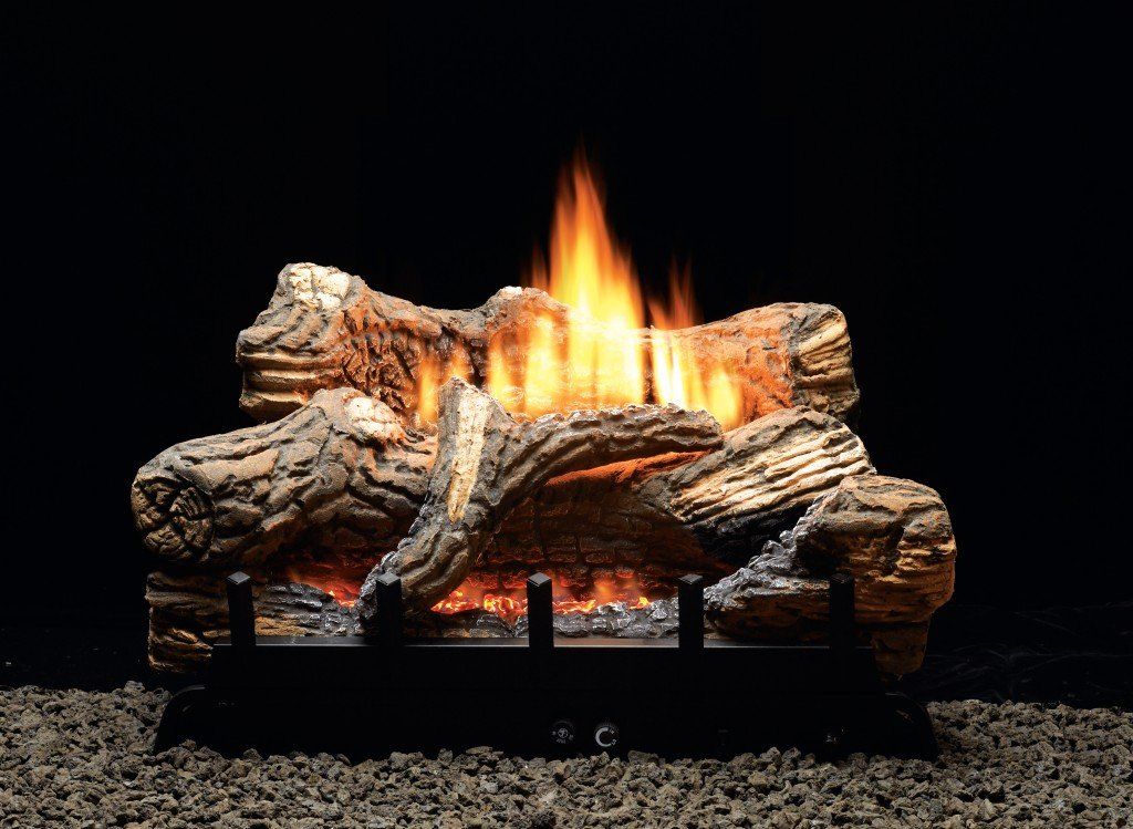 Gas fireplace with burning logs. Orange and yellow flames. Dark setting.