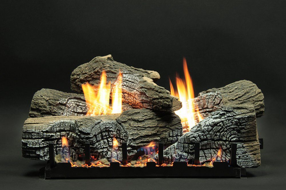 Gas fireplace logs with flames against a dark background.