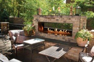 A patio with a fireplace and a table and chairs