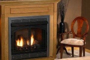 A fireplace with a chair in front of it in a living room.