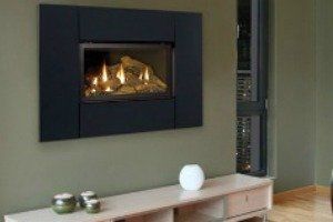 There is a fireplace on the wall in the living room.
