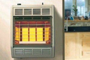 A heater is hanging on a wall in a kitchen