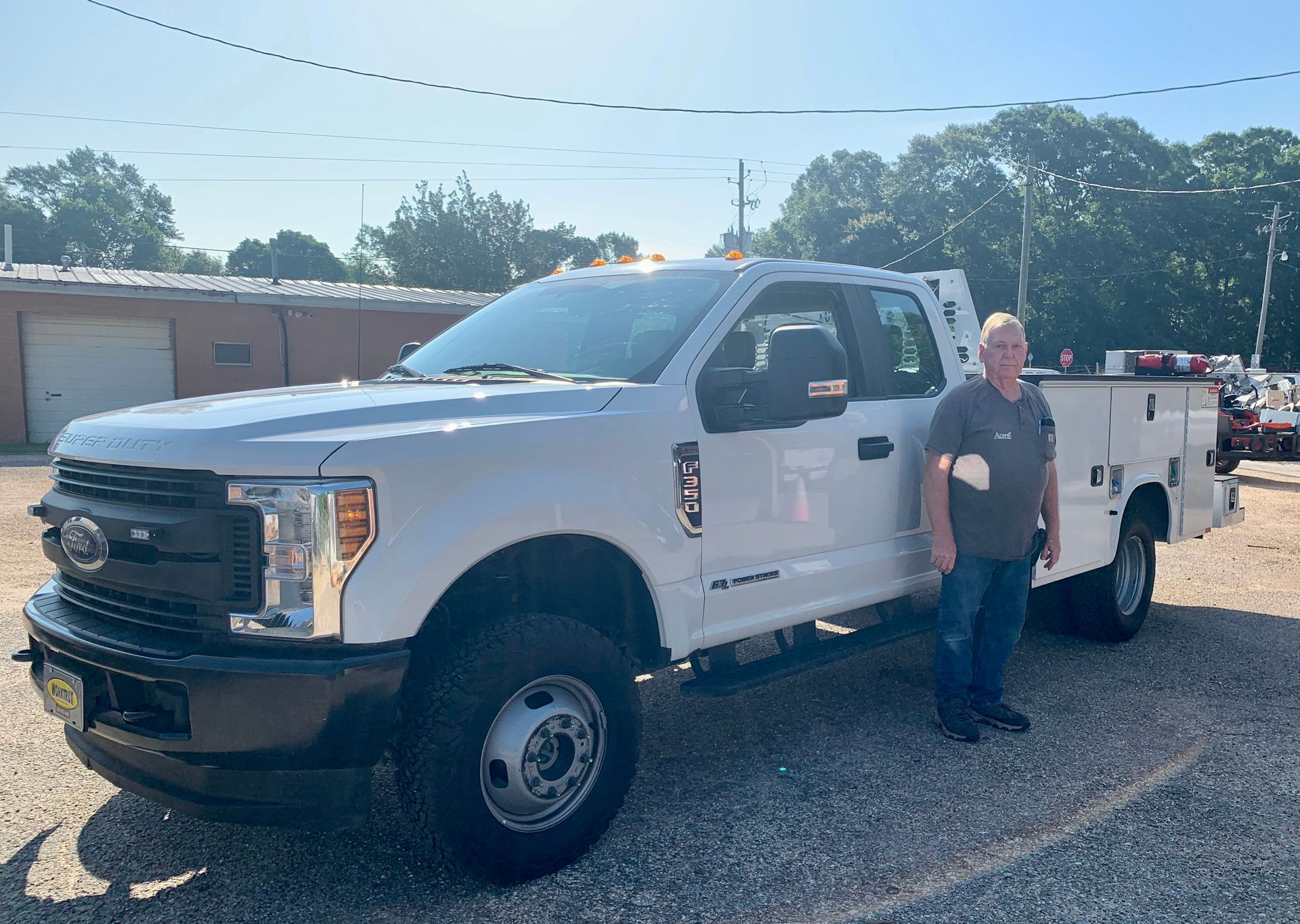 A man is standing in front of a white truck.