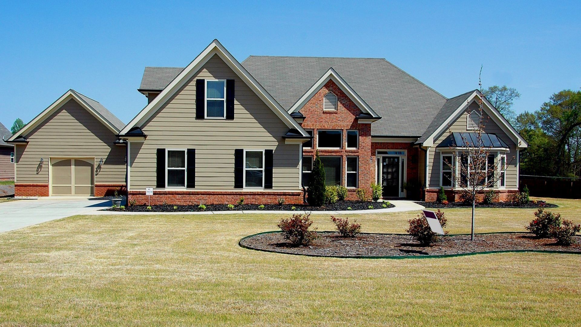 A large house with a lush green lawn in front of it
