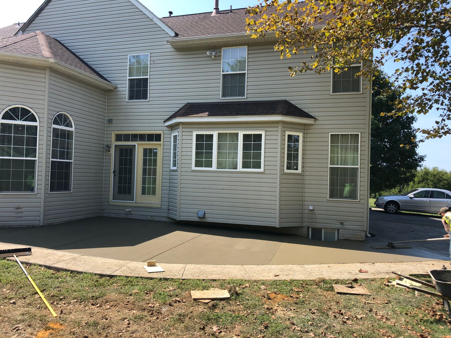 A white house with a table and chairs in front of it