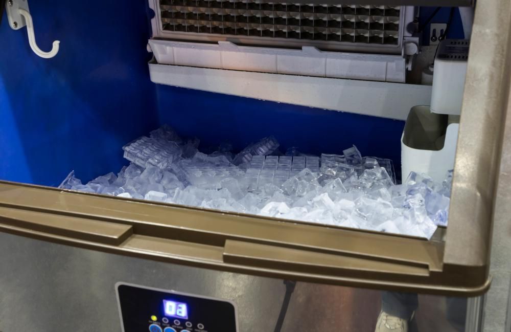 A Stainless Steel Ice Maker Is Filled with Ice Cubes — Cool Blue Ice & Water in Gunnedah, NSW