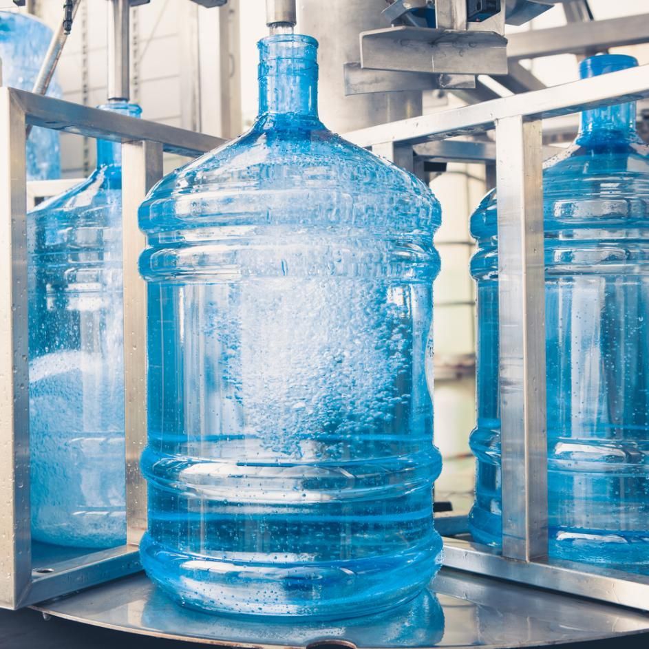 A Large Bottle of Water Is Sitting on Top of A Machine — Cool Blue Ice & Water in Muswellbrook, NSW