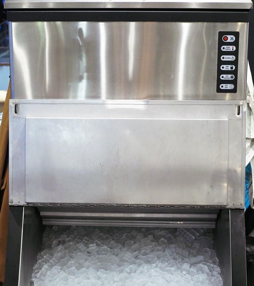 A Stainless Steel Ice Machine Is Filled with Ice Cubes — Cool Blue Ice & Water in Muswellbrook, NSW