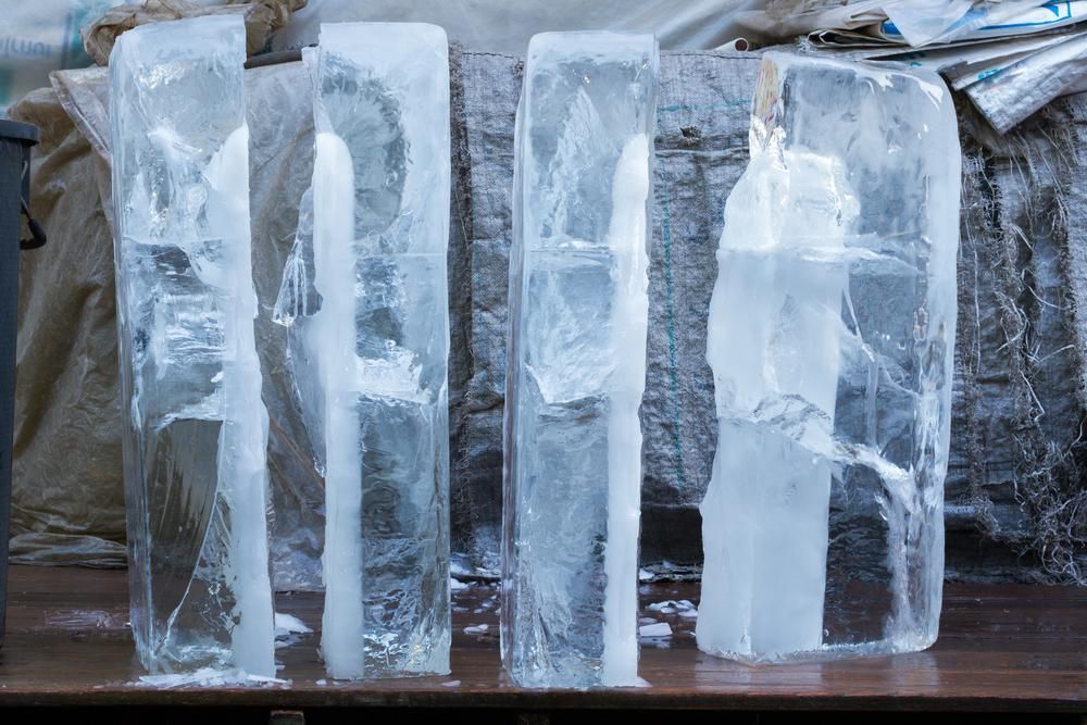 A Row of Ice Cubes Sitting on Top of A Wooden Table — Cool Blue Ice & Water in Mudgee, NSW