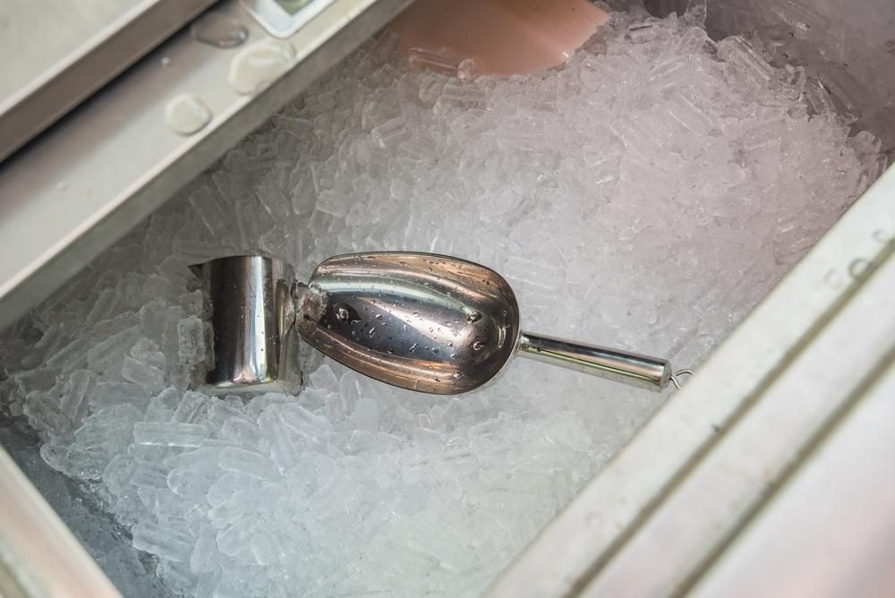 A Scoop of Ice Is Sitting in A Container of Ice — Cool Blue Ice & Water in Moree, NSW
