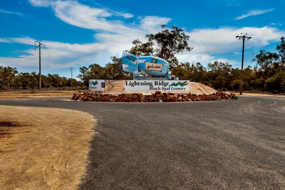 A Sign on The Side of A Road that Says Lightning Ridge — Cool Blue Ice & Water in Lightning Ridge, NSW