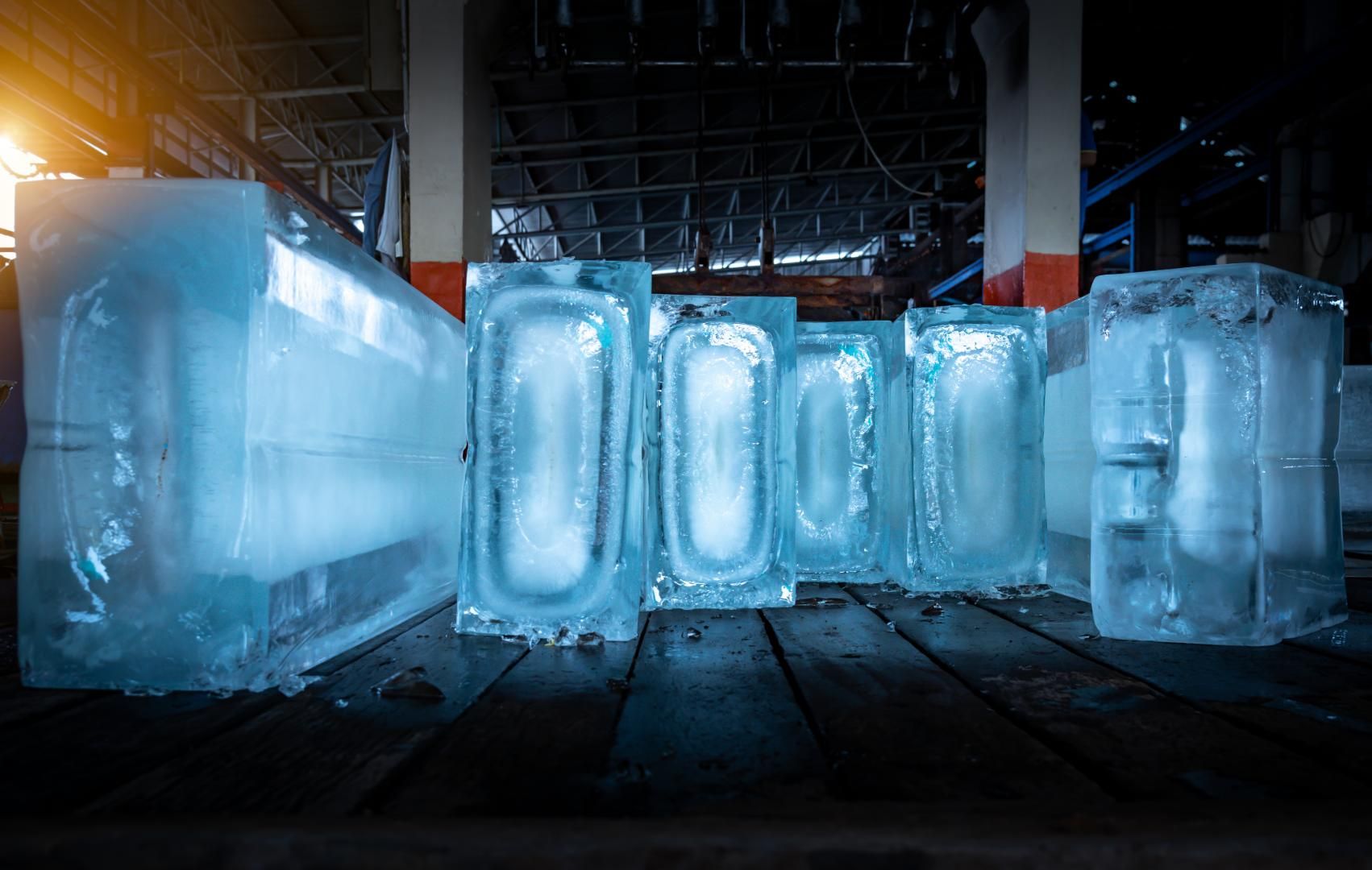 A Bunch of Ice Cubes Are Sitting on A Wooden Floor in A Building — Cool Blue Ice & Water in Tamworth, NSW