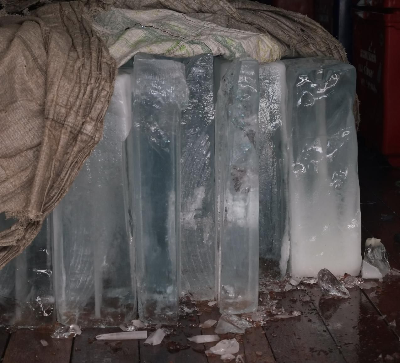 A Pile of Ice Cubes Are Sitting on A Wooden Floor — Cool Blue Ice & Water in Forbes, NSW