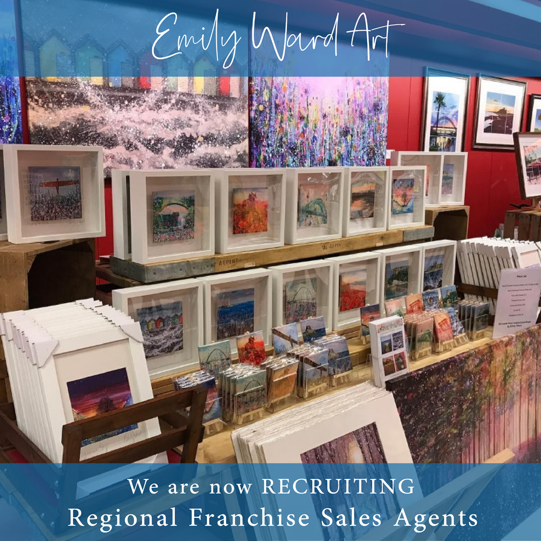 Art display table with framed art and recruitment ad for sales agents.