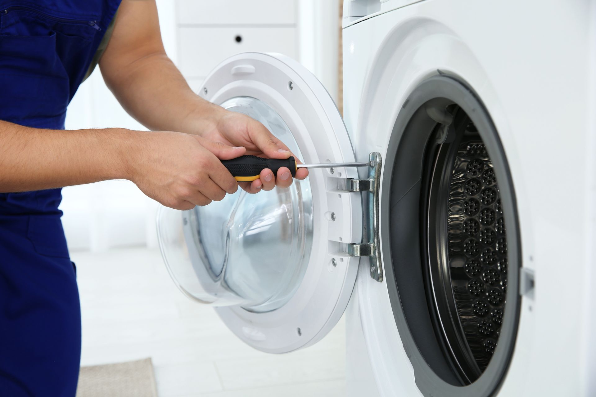 technician repairing washing machine
