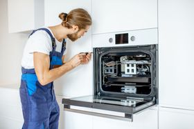 technician performing oven repair services