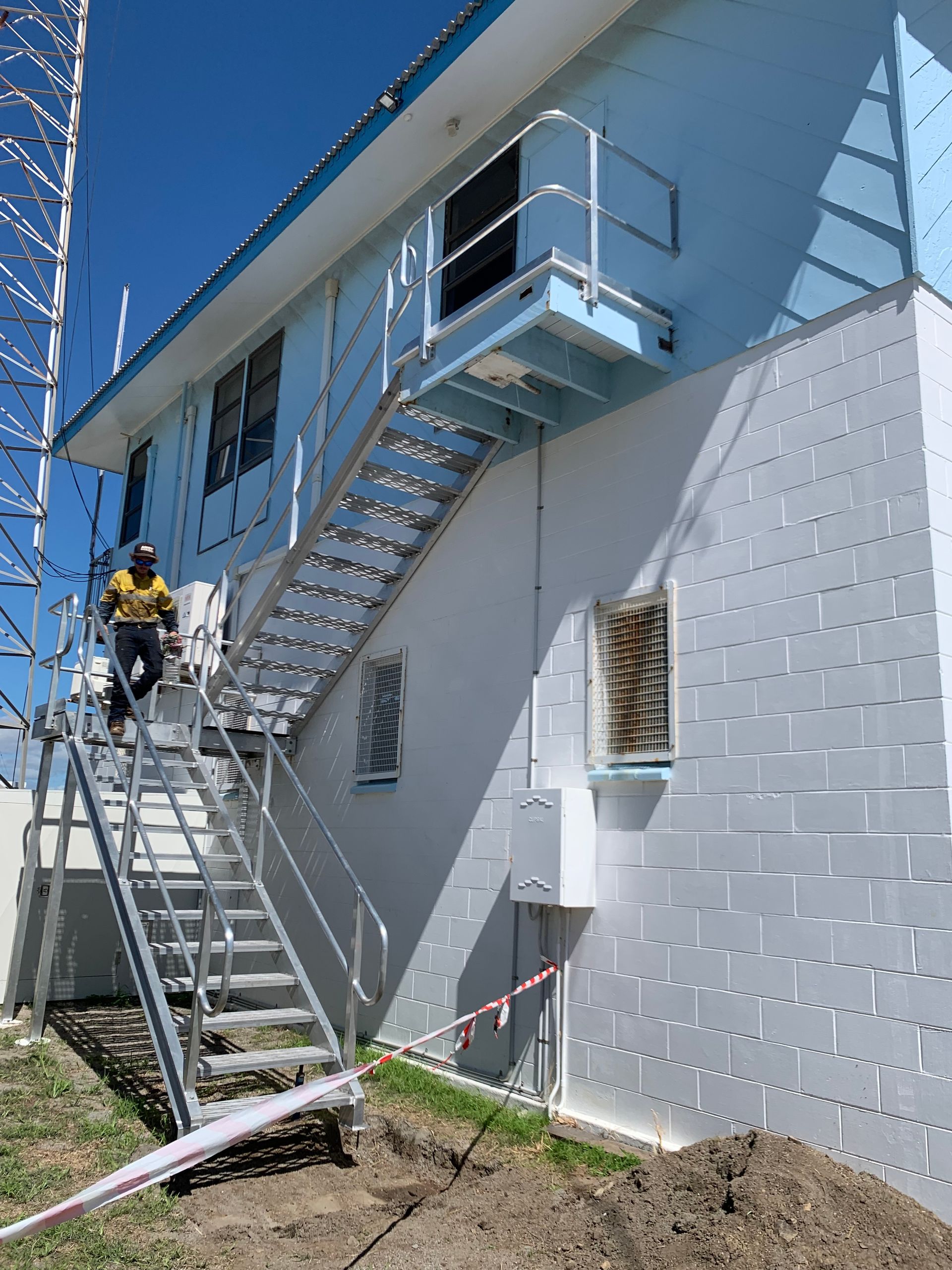 A Man In A Vest Is Writing On A Clipboard — Kaplan Engineering Pty Ltd In Bowen, QLD