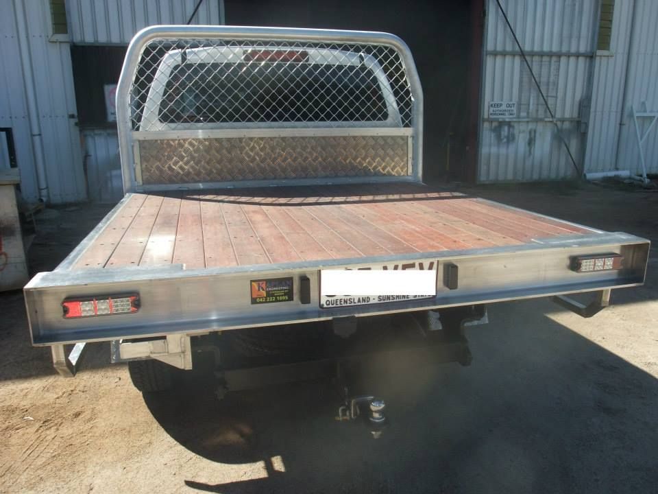 A Truck With A Wooden Bed Is Parked In Front Of A Building — Kaplan Engineering Pty Ltd In Bowen, QLD