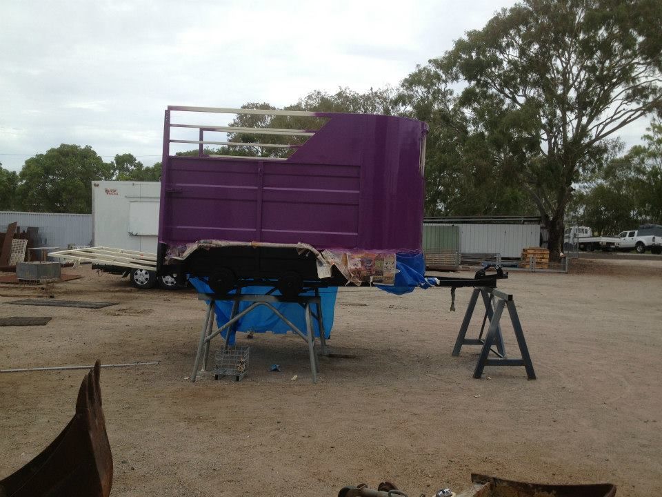 A Purple Trailer Is Sitting In A Dirt Field — Kaplan Engineering Pty Ltd In Bowen, QLD