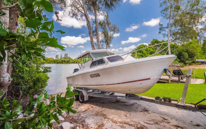 Boat Being Loaded Onto Trailer — Caravan Park in Woombah, NSW