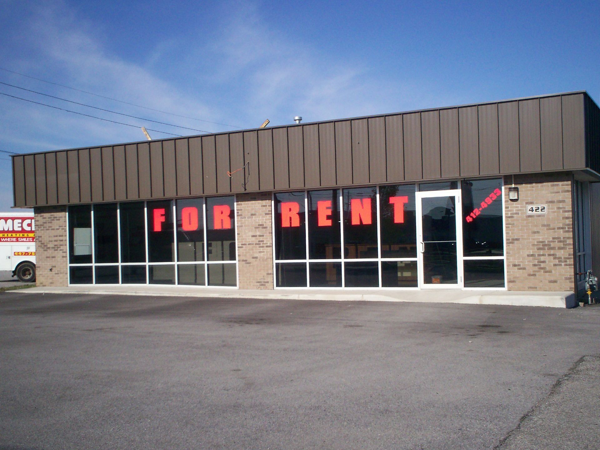 A for rent sign is on the side of a building
