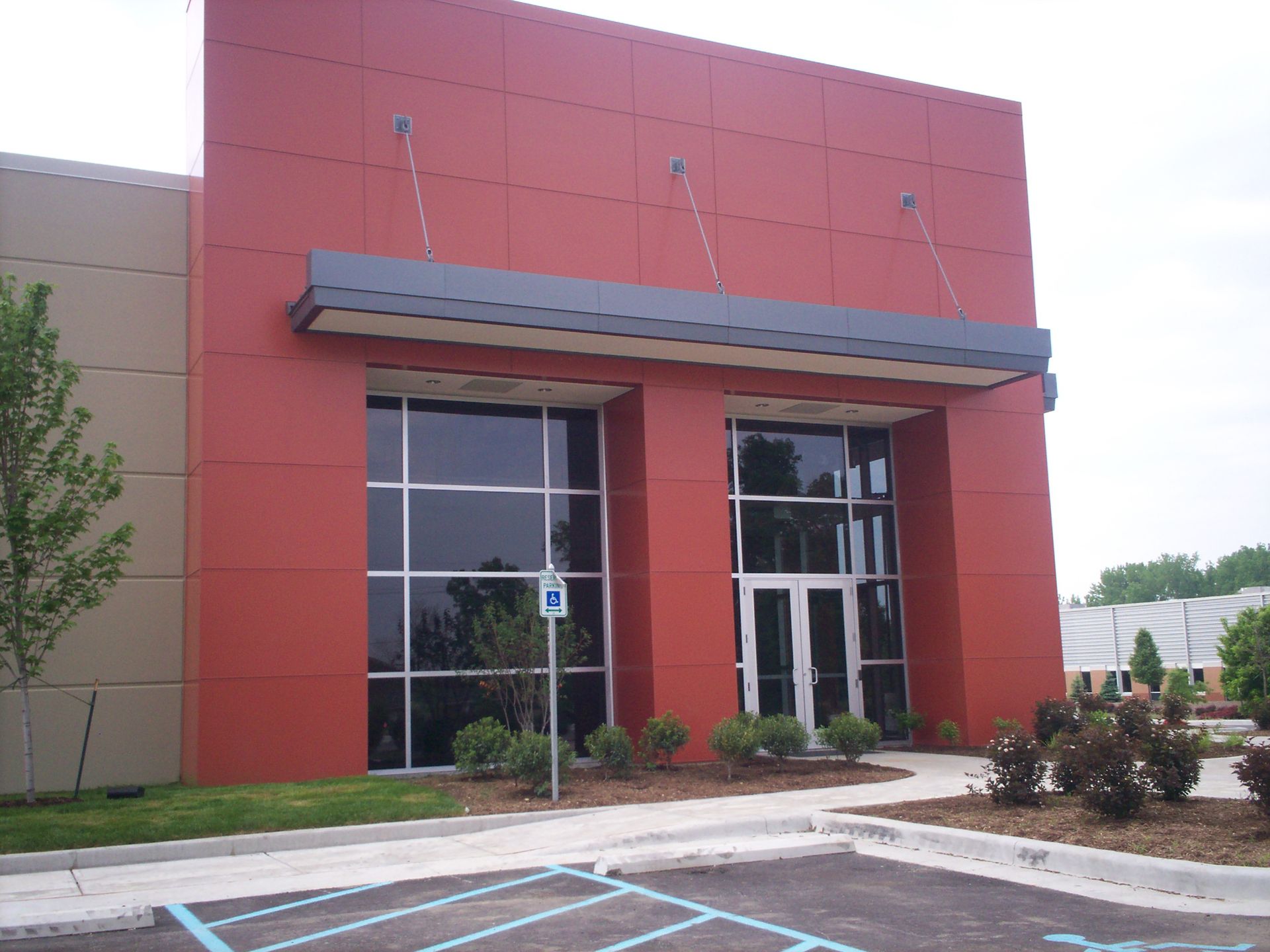 A red building with a handicapped parking sign in front of it
