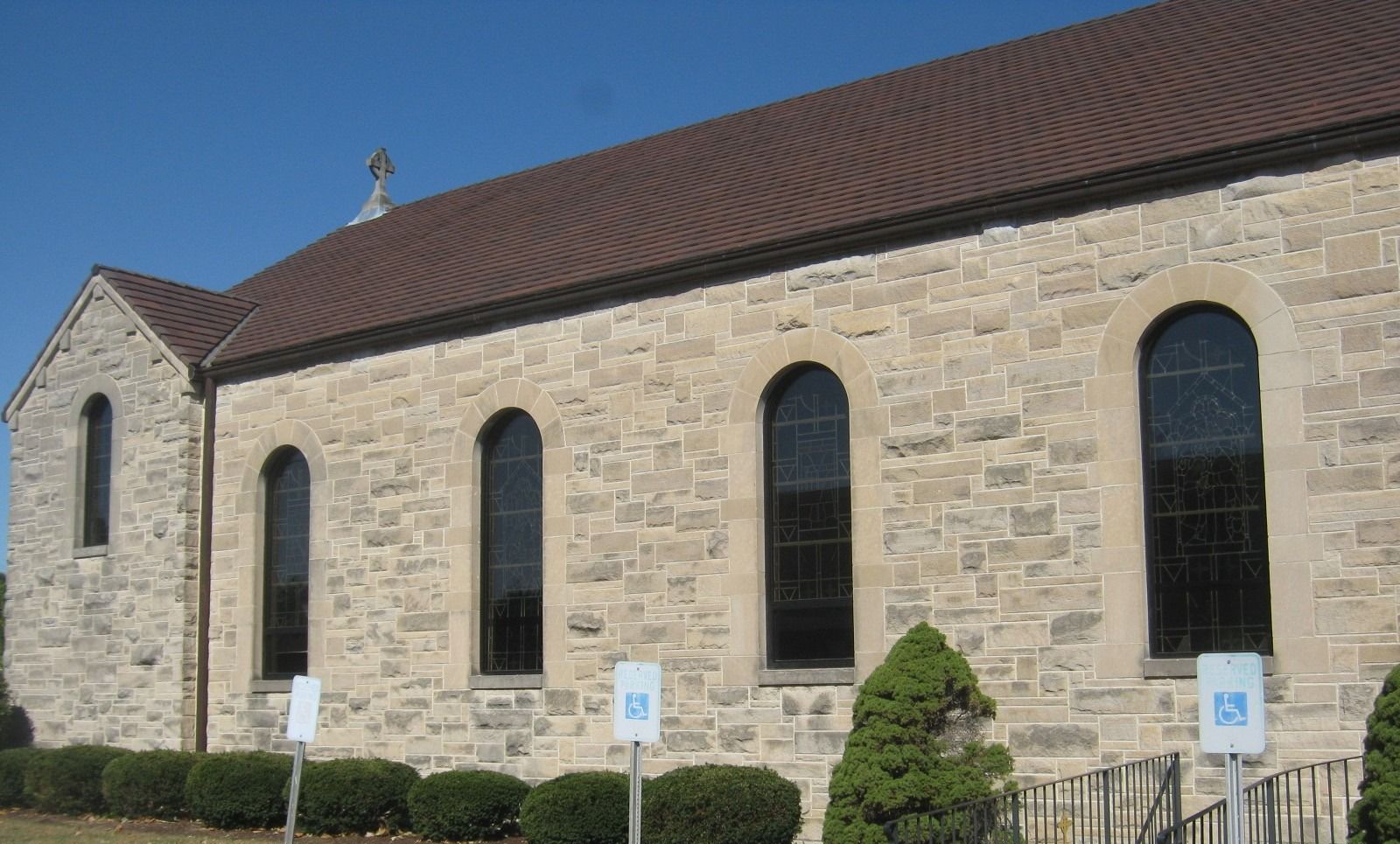 A church with a handicapped parking sign in front of it