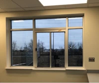 A large window with a sliding glass door in a room