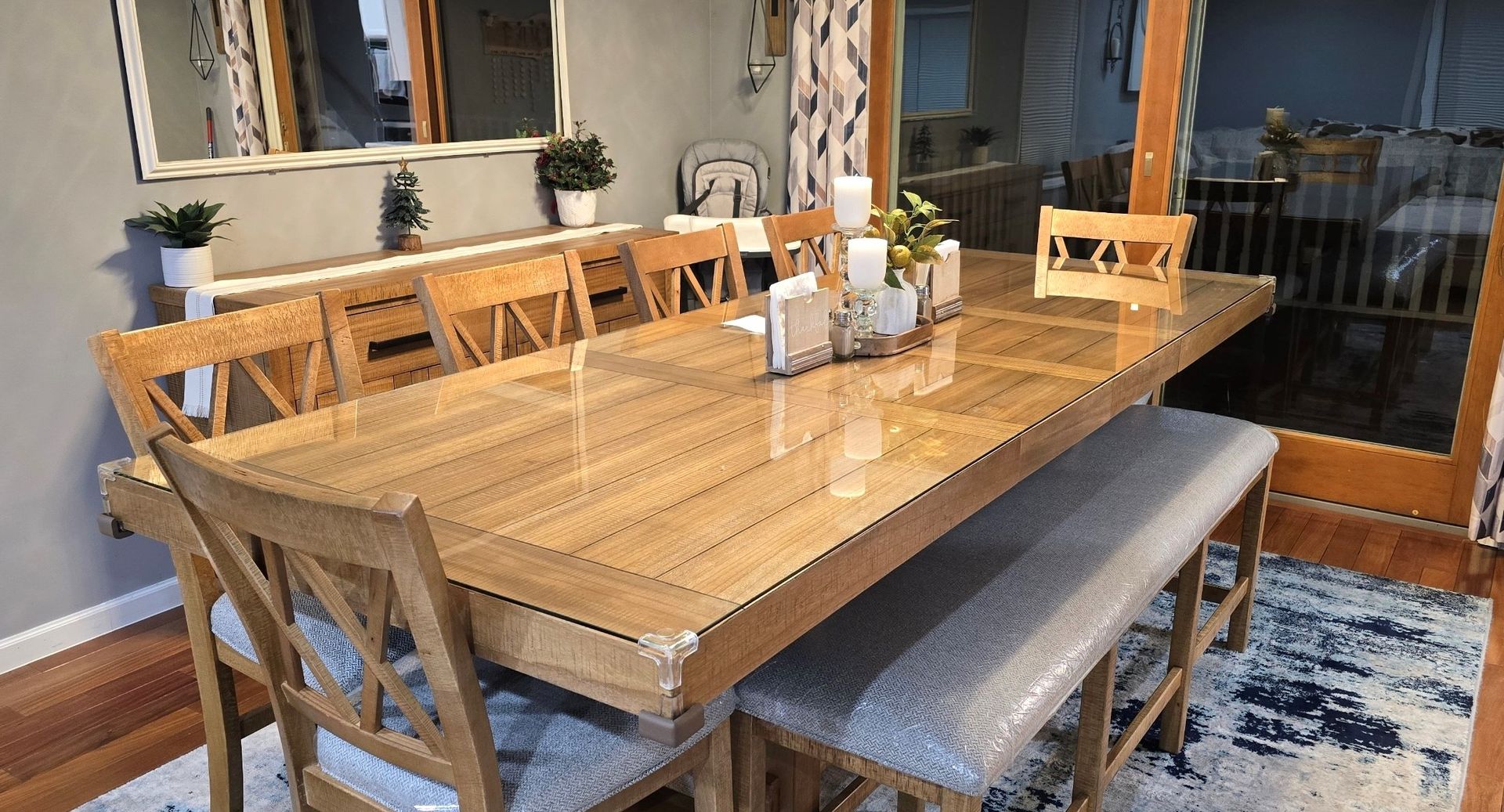 A wooden dining table with chairs and a bench in a dining room.