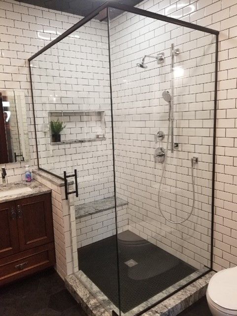 A bathroom with a walk in shower and a toilet.