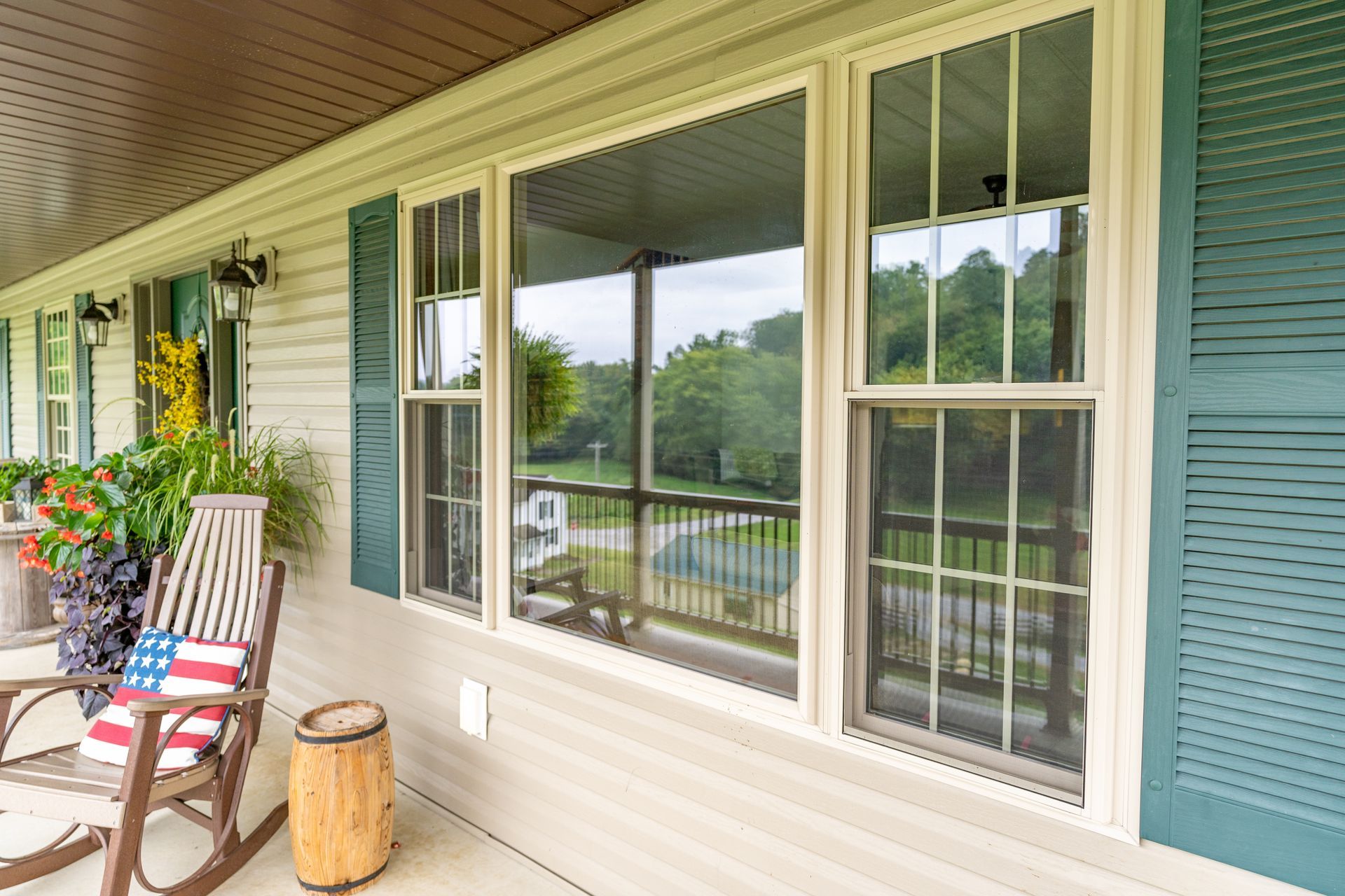 There is a rocking chair on the porch of a house.