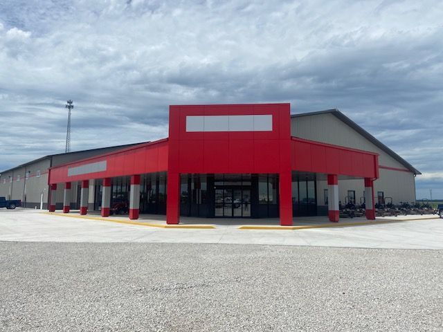 A large building with a red awning and pillars
