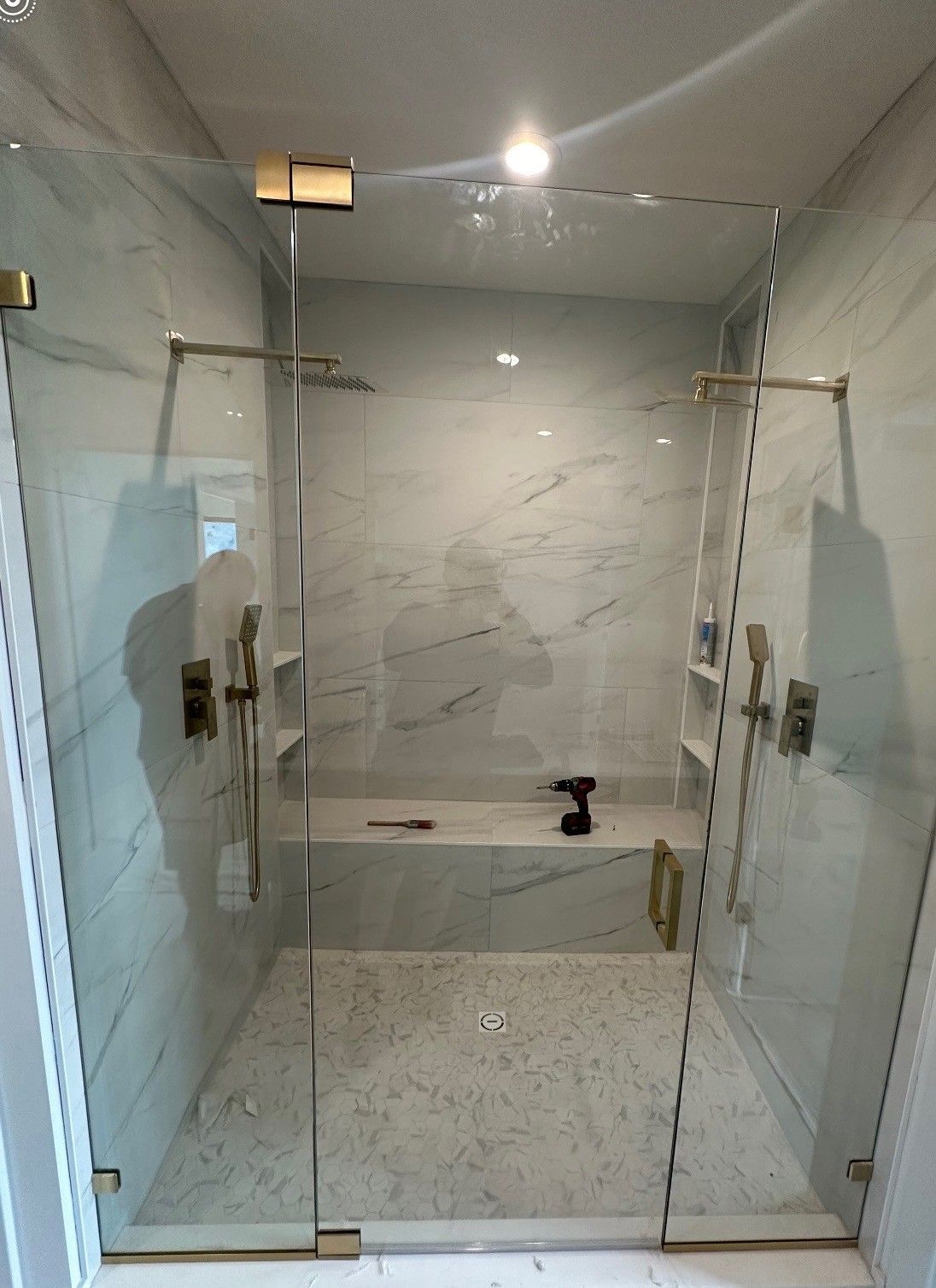 A bathroom with a walk in shower and a bathtub.